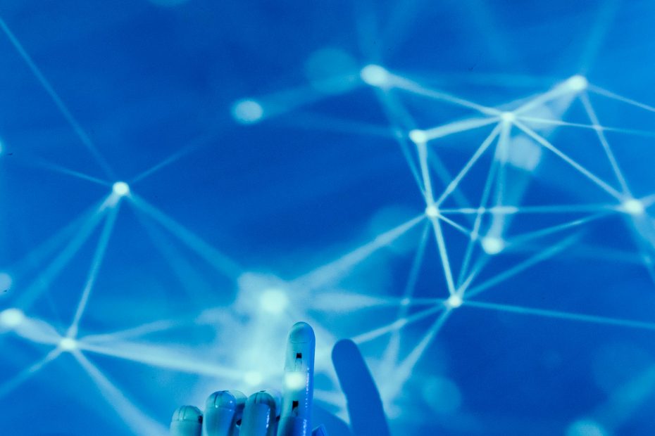 Futuristic robotic hand touching a digital network on a blue background.